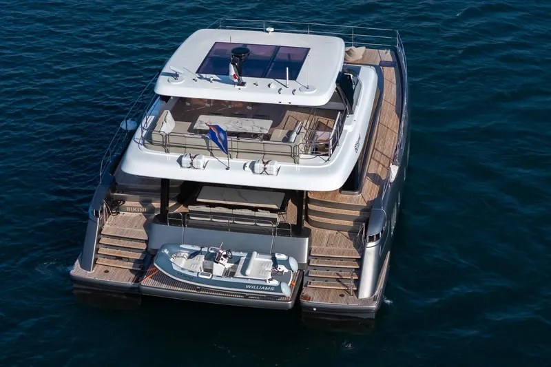  Yacht Photos Pics 2023 Sunreef 60 Power yacht on water, showcasing luxury design and spacious deck.
