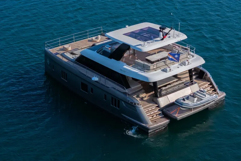  Yacht Photos Pics 2023 Sunreef 60 Power yacht on open water, showcasing luxury design and spacious decks.