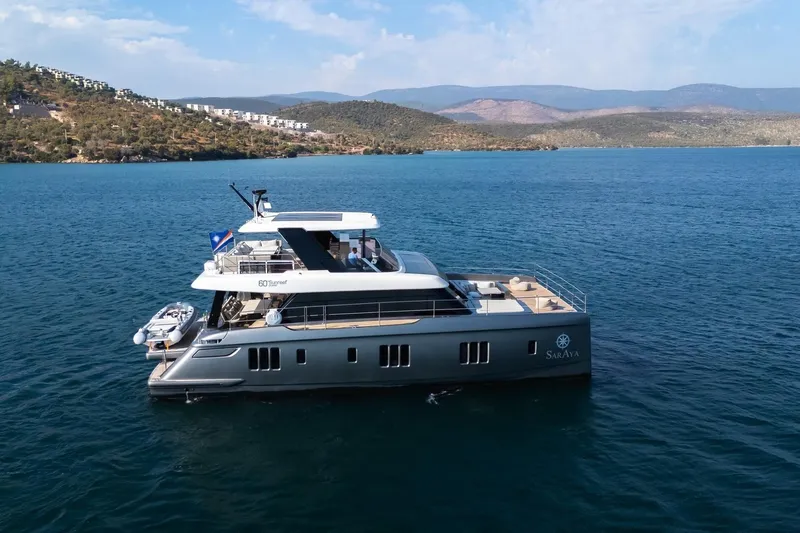  Yacht Photos Pics 2023 Sunreef 60 Power yacht cruising on serene blue waters.