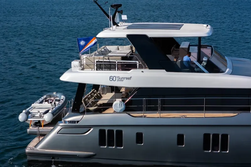  Yacht Photos Pics 2023 Sunreef 60 Power yacht on water, featuring sleek design and luxury amenities.