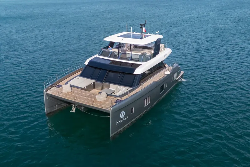  Yacht Photos Pics Luxurious 2023 Sunreef 60 Power yacht cruising on open water.