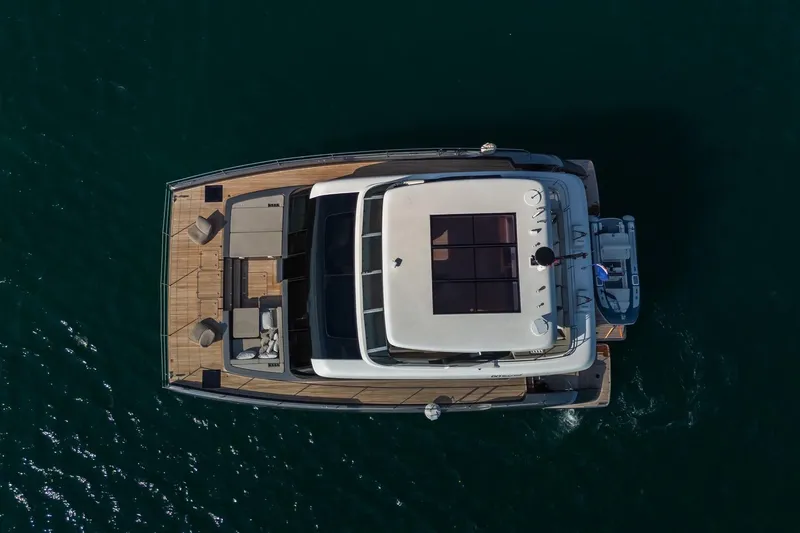  Yacht Photos Pics Aerial view of 2023 Sunreef 60 Power yacht on calm water.
