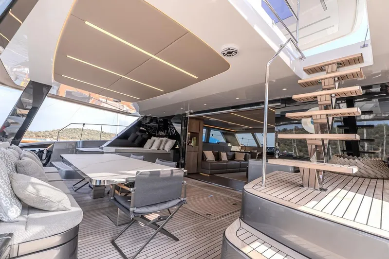  Yacht Photos Pics Luxurious Sunreef 60 Power yacht interior, featuring modern seating and elegant wooden staircase, 2023 model.