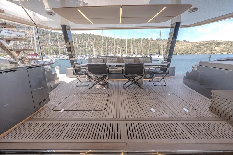  Yacht Photos Pics Luxurious Sunreef 60 Power yacht deck, 2023 model, with elegant seating and scenic marina view.