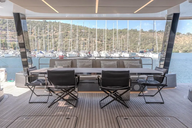 Yacht Photos Pics Luxurious Sunreef 60 Power yacht deck with elegant seating, overlooking marina and scenic views.