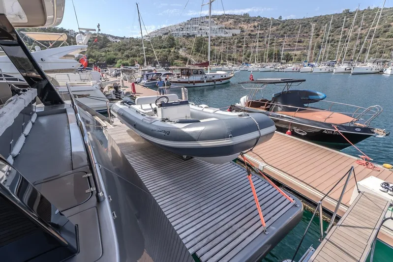  Yacht Photos Pics 2023 Sunreef 60 Power yacht docked with inflatable boat on deck, marina view.