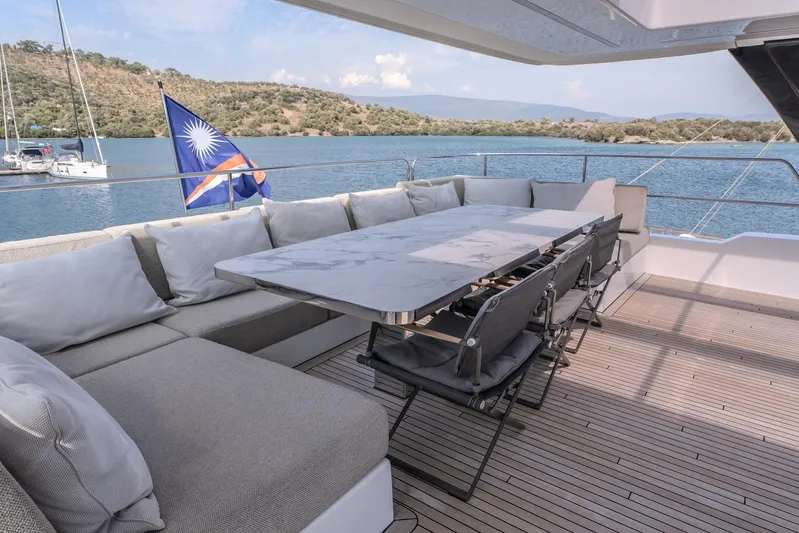  Yacht Photos Pics Luxurious Sunreef 60 Power yacht deck with elegant seating, table, and scenic water view.