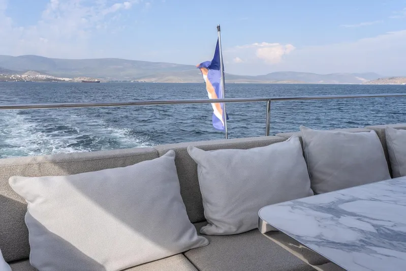  Yacht Photos Pics Luxurious Sunreef 60 Power yacht deck with cushions, ocean view, and flag, 2023 model.