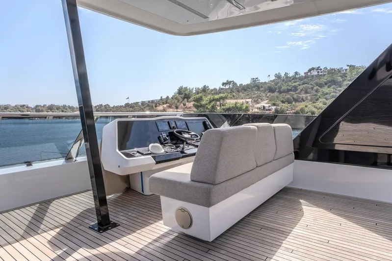  Yacht Photos Pics 2023 Sunreef 60 Power yacht helm station with modern controls and scenic water view.