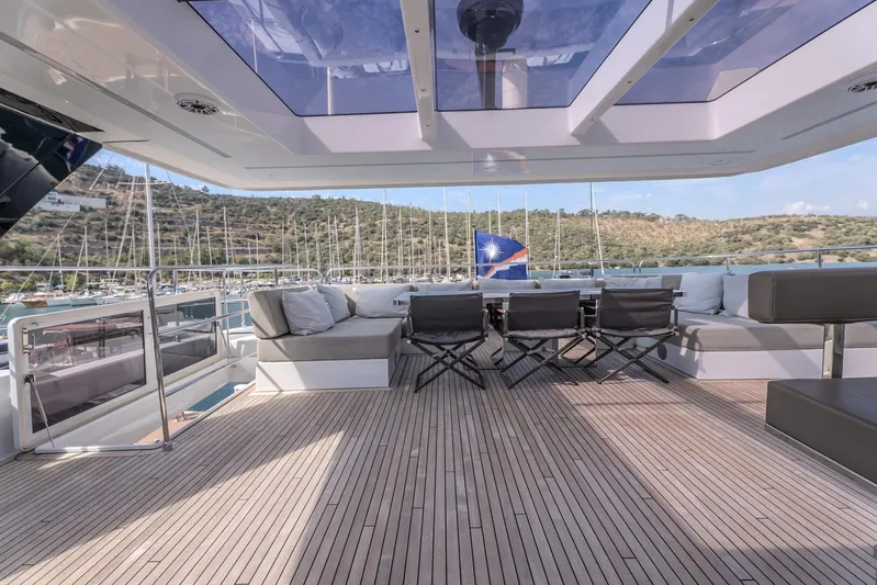  Yacht Photos Pics Luxurious Sunreef 60 Power yacht deck with seating, 2023 model, scenic marina view.
