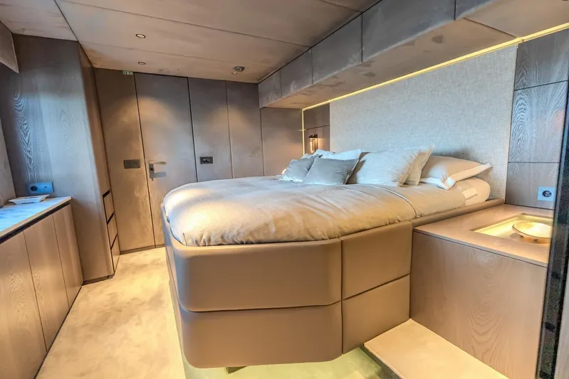  Yacht Photos Pics Luxurious bedroom interior of 2023 Sunreef 60 Power yacht with modern design and ambient lighting.