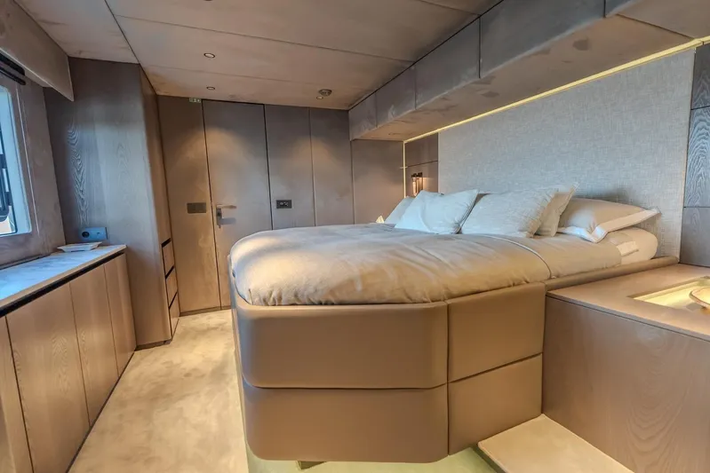  Yacht Photos Pics Luxurious bedroom interior of 2023 Sunreef 60 Power yacht with modern design and cozy ambiance.
