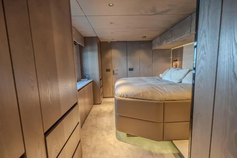  Yacht Photos Pics Luxurious bedroom interior of 2023 Sunreef 60 Power yacht with modern wood finishes.