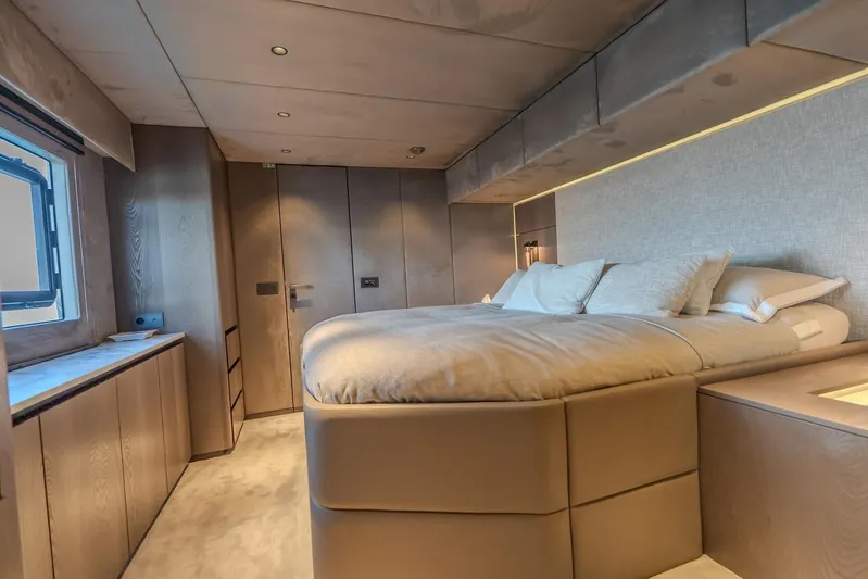  Yacht Photos Pics Luxurious bedroom interior of 2023 Sunreef 60 Power yacht, featuring modern design and cozy bedding.