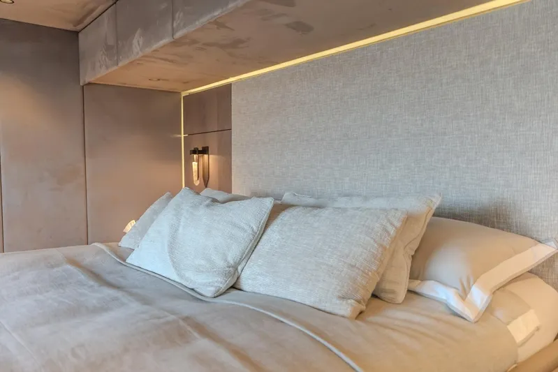  Yacht Photos Pics Luxurious bedroom interior on 2023 Sunreef 60 Power yacht, featuring elegant bedding and ambient lighting.