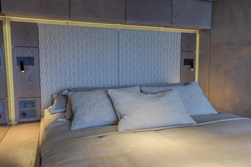  Yacht Photos Pics Luxurious bedroom interior of 2023 Sunreef 60 Power yacht with elegant bedding and ambient lighting.