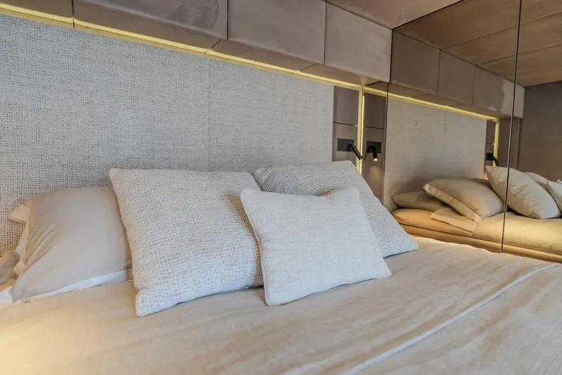  Yacht Photos Pics Luxurious bedroom interior on 2023 Sunreef 60 Power yacht, featuring elegant bedding and ambient lighting.