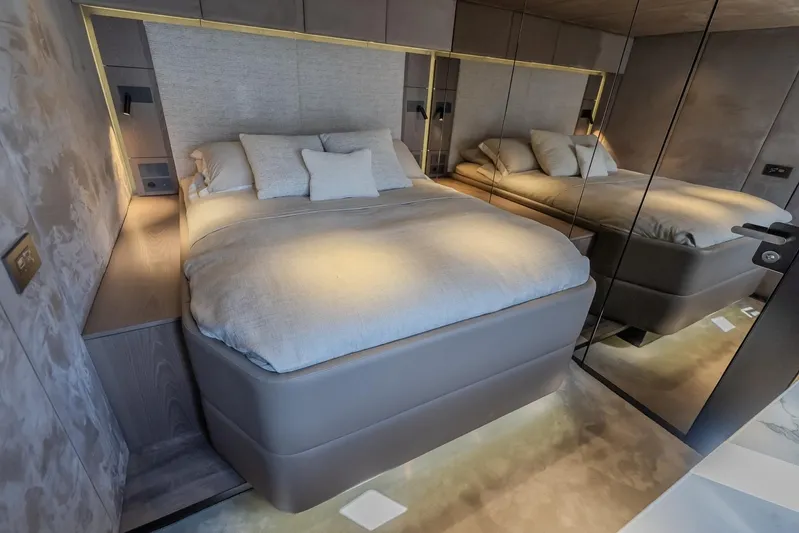  Yacht Photos Pics Luxurious bedroom interior of 2023 Sunreef 60 Power yacht with modern design and ambient lighting.