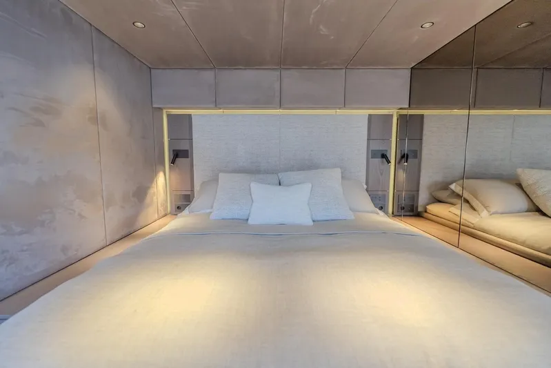  Yacht Photos Pics Luxurious bedroom interior of 2023 Sunreef 60 Power yacht with modern design and soft lighting.