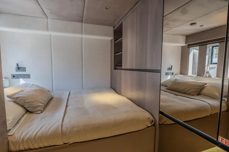  Yacht Photos Pics Luxurious bedroom interior of 2023 Sunreef 60 Power yacht with modern design and cozy bedding.