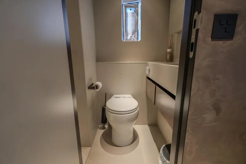  Yacht Photos Pics Modern bathroom interior on 2023 Sunreef 60 Power yacht, featuring sleek design and compact layout.