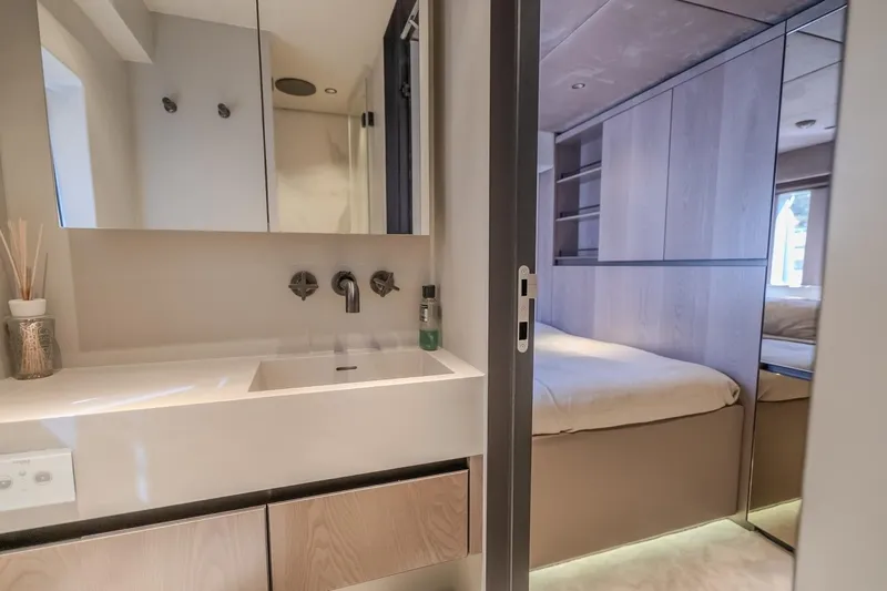  Yacht Photos Pics Luxurious interior of 2023 Sunreef 60 Power yacht featuring modern bathroom and cozy bedroom.