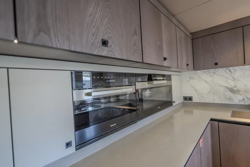  Yacht Photos Pics Modern kitchen in 2023 Sunreef 60 Power yacht with sleek cabinetry and built-in appliances.