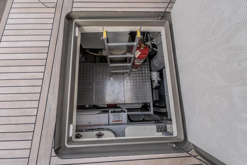  Yacht Photos Pics Engine room access hatch on 2023 Sunreef 60 Power yacht, featuring ladder and fire extinguisher.