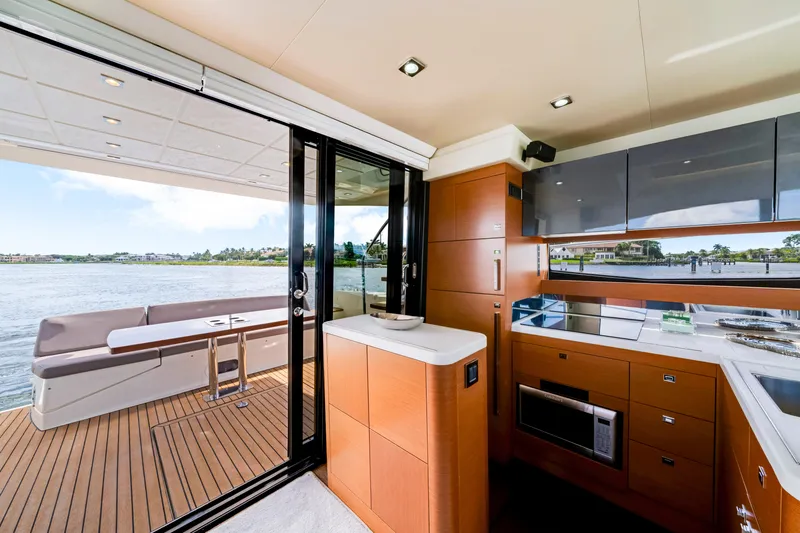 Our Trade Yacht Photos Pics Luxurious interior of 2017 Prestige 560 yacht with modern kitchen and scenic water view.