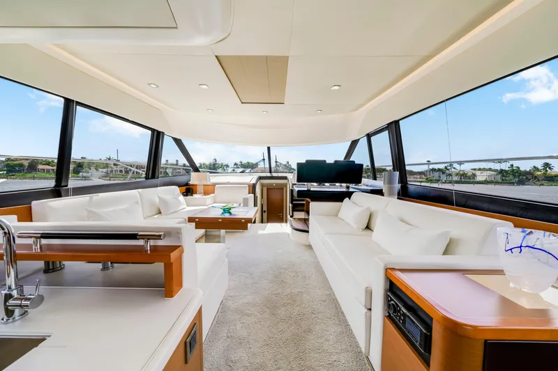 Our Trade Yacht Photos Pics Luxurious interior of 2017 Prestige 560 yacht with elegant white seating and panoramic windows.
