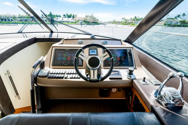 Our Trade Yacht Photos Pics Cockpit of 2017 Prestige 560 yacht with modern navigation controls and scenic water view.