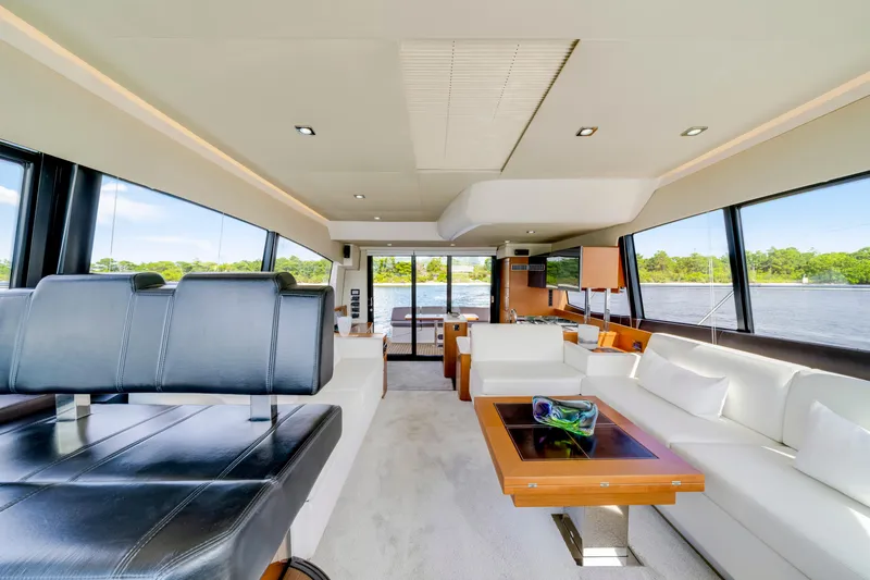 Our Trade Yacht Photos Pics Luxurious interior of 2017 Prestige 560 yacht with modern furnishings and panoramic windows.