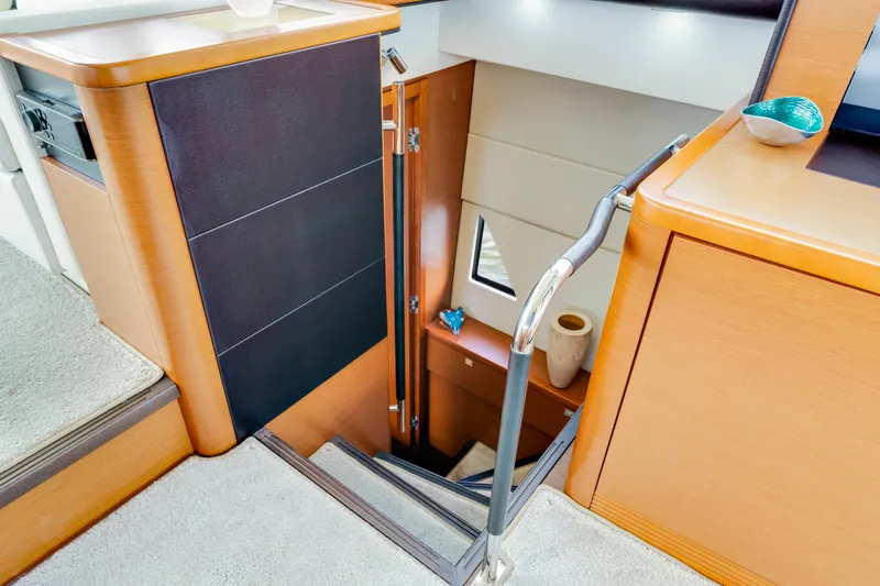 Our Trade Yacht Photos Pics Interior staircase of a 2017 Prestige 560 yacht, featuring modern wood and metal design.
