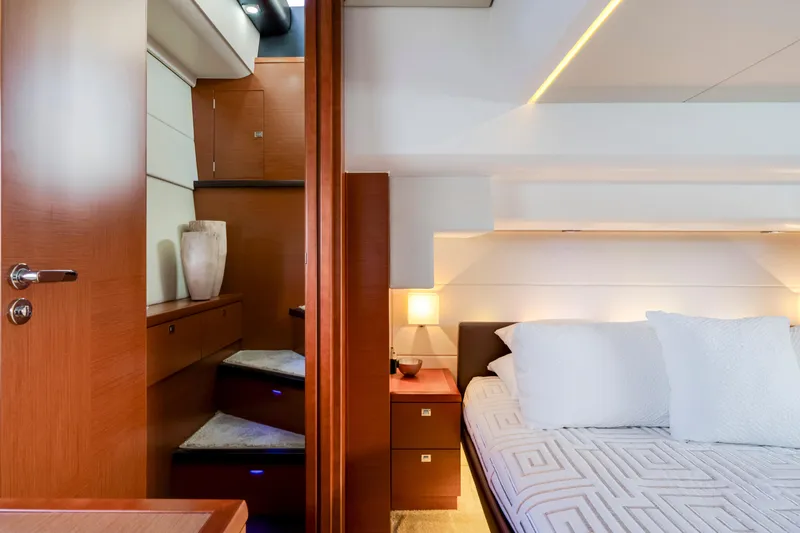 Our Trade Yacht Photos Pics Luxurious interior of 2017 Prestige 560 yacht with elegant bedroom and wooden staircase.