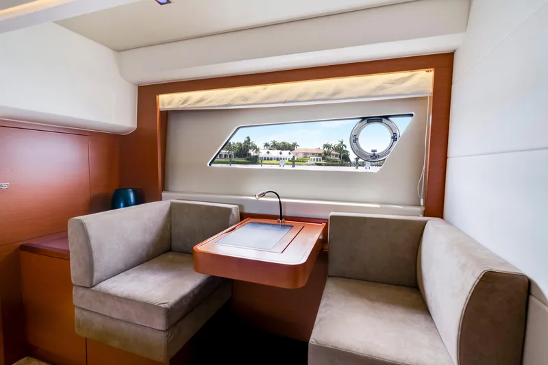 Our Trade Yacht Photos Pics Luxurious interior of 2017 Prestige 560 yacht with elegant seating and scenic window view.