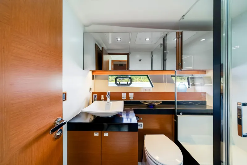 Our Trade Yacht Photos Pics Luxurious bathroom interior of 2017 Prestige 560 yacht with modern fixtures and wood accents.