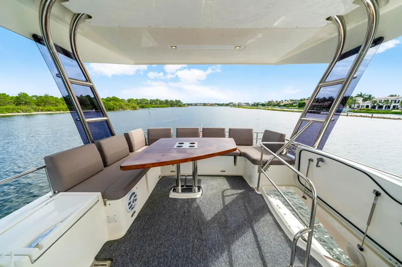 Our Trade Yacht Photos Pics Luxurious 2017 Prestige 560 yacht deck with seating and scenic water view.