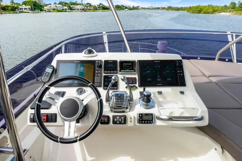 Our Trade Yacht Photos Pics Cockpit of 2017 Prestige 560 yacht with advanced navigation controls and scenic waterway view.