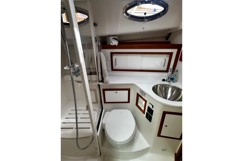 Sull Mates Yacht Photos Pics Luxurious bathroom in 2019 Back Cove 37 yacht with shower, sink, and toilet.