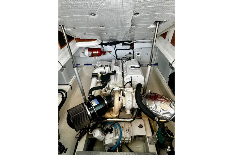 Sull Mates Yacht Photos Pics Engine compartment of a 2019 Back Cove 37 boat, showcasing mechanical components and fire extinguisher.