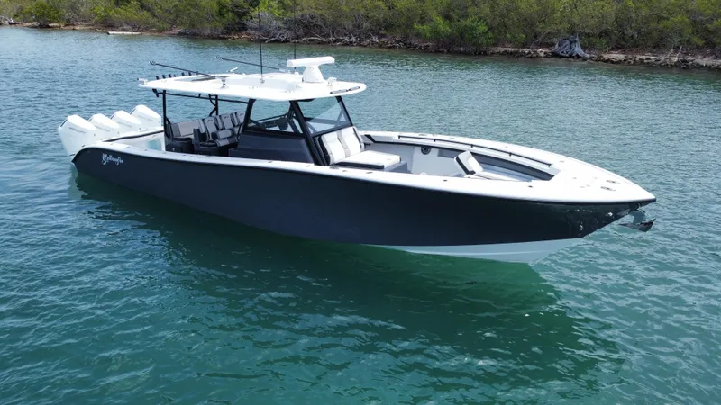  Yacht Photos Pics 2023 Yellowfin 42 boat on calm water, featuring sleek design and modern amenities.