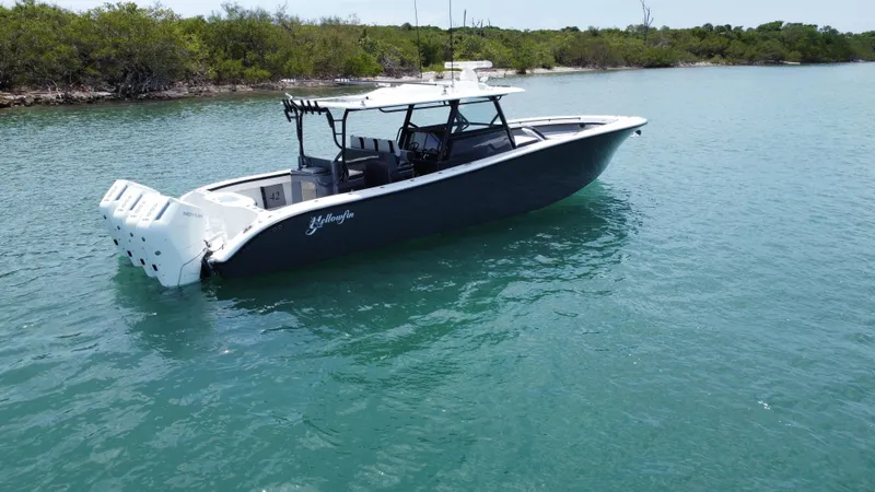  Yacht Photos Pics 2023 Yellowfin 42 boat on calm water, featuring sleek design and powerful engines.