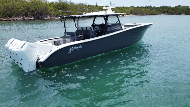  Yacht Photos Pics 2023 Yellowfin 42 boat on clear water, featuring sleek design and powerful engines.