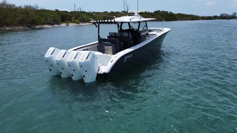  Yacht Photos Pics 2023 Yellowfin 42 boat with multiple engines on calm water.