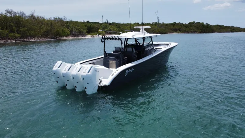  Yacht Photos Pics 2023 Yellowfin 42 boat with multiple engines on calm water.