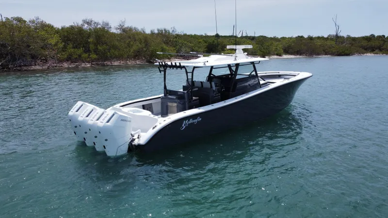  Yacht Photos Pics 2023 Yellowfin 42 boat with multiple engines on calm water.