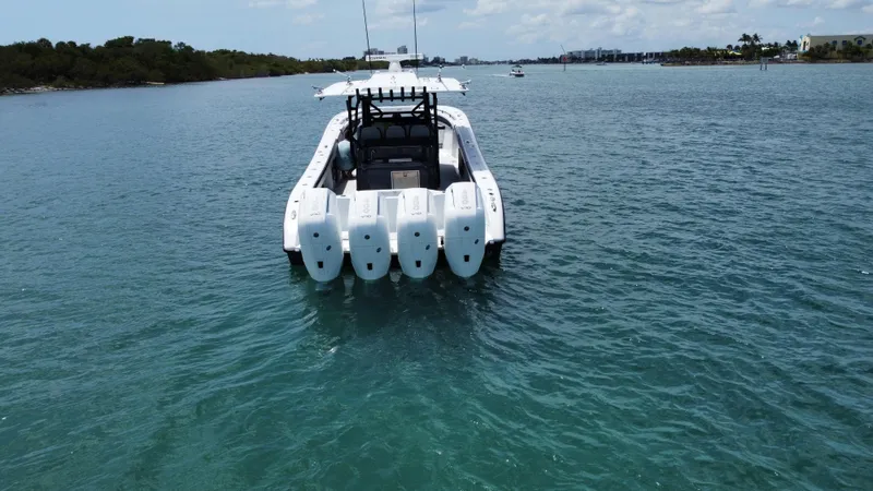  Yacht Photos Pics 2023 Yellowfin 42 boat with four engines on calm water.