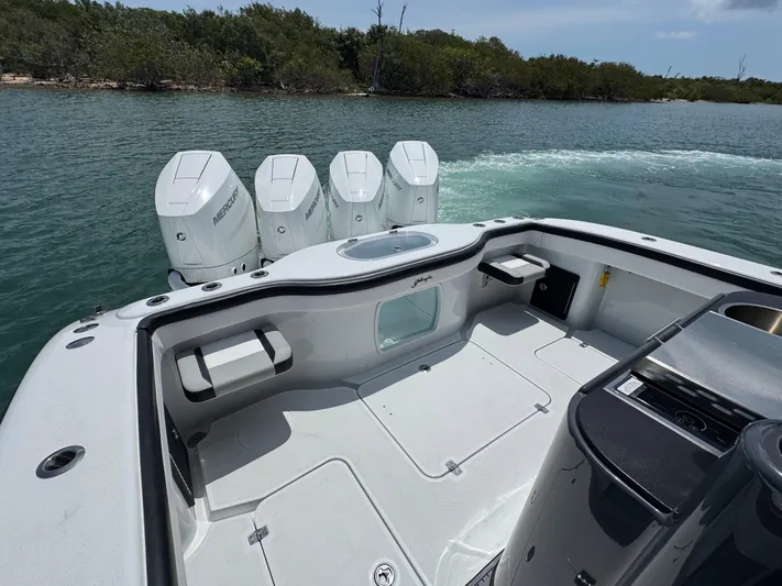  Yacht Photos Pics 2023 Yellowfin 42 boat with four outboard motors on a calm waterway.