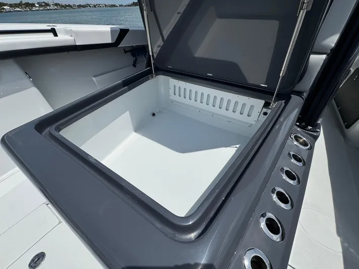  Yacht Photos Pics Open storage compartment on 2023 Yellowfin 42 boat, featuring sleek design and multiple cup holders.