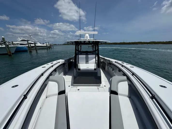  Yacht Photos Pics 2023 Yellowfin 42 boat on water, clear sky, luxury seating, and sleek design.